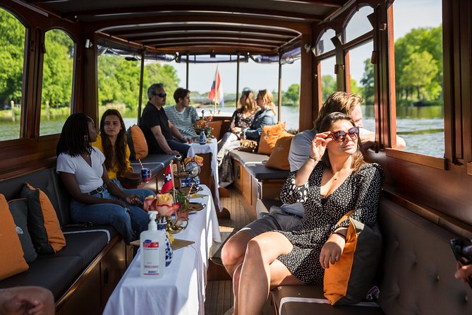 Amsterdam Classic Saloon Boat Cruise with Drinks and Cheese - What the guides add, and where the cruise falls short